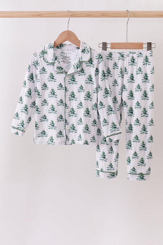 Children's pajama set with tree pattern on hangers against a white background